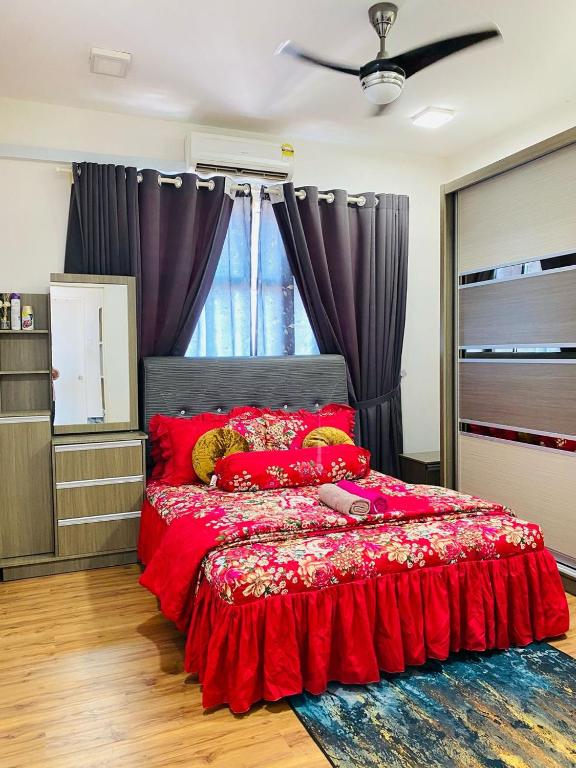 a bedroom with a red bed with red pillows at EM Suite Home 2Bedroom Dperdana Apartment in Kota Bharu