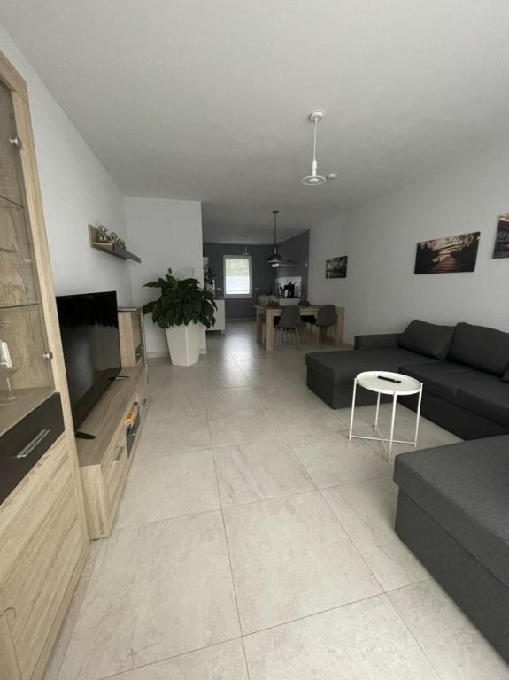 a large living room with a couch and a table at Ferienhaus am Ruppiner See in Neuruppin