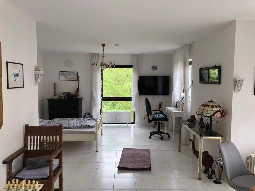 a living room with a bed and a desk at Apartment Naheblick in Bad Kreuznach