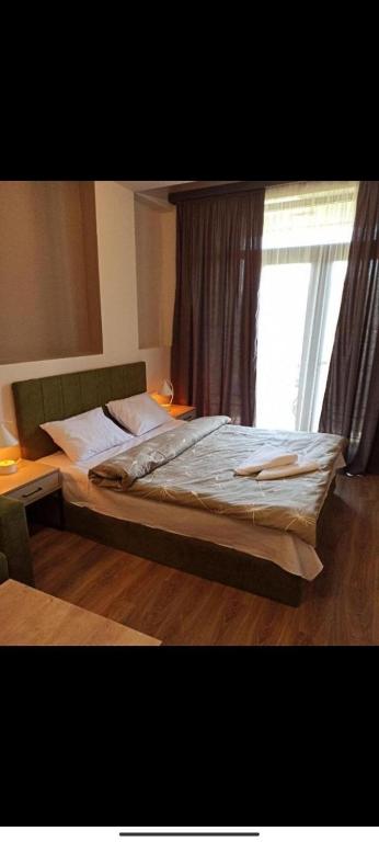 a large bed in a bedroom with a window at tsaghkadzor apartment kechi house in Tsaghkadzor
