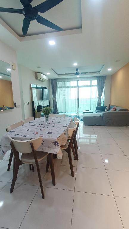 a dining table and chairs in a living room at Sky Loft Premium Bukit Indah with Garden View & Nflix HBO A30 in Johor Bahru
