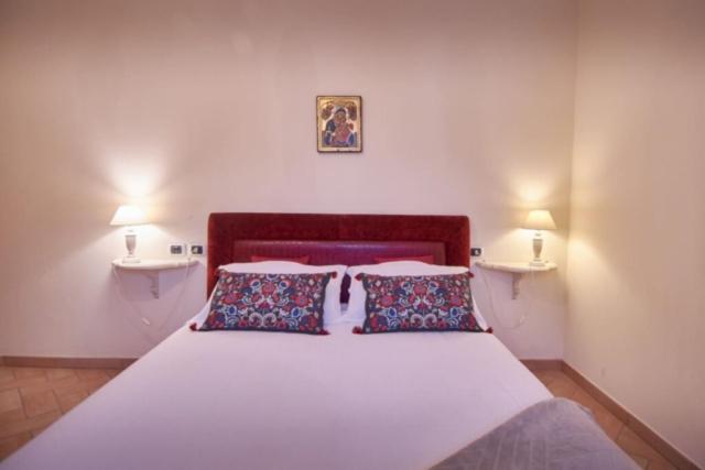 A bed or beds in a room at Alle Porte di Assisi