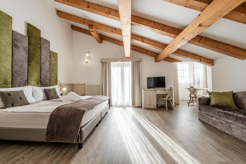 Postel nebo postele na pokoji v ubytování Hotel Sasso Rosso