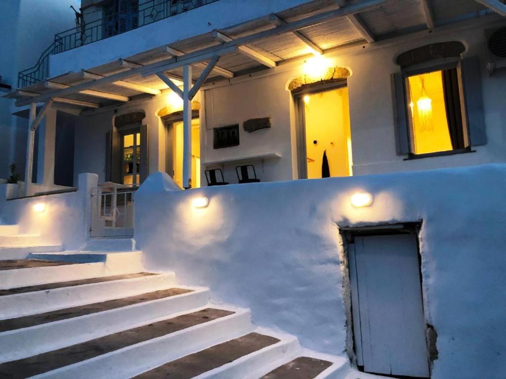 a white house with stairs and a door at Milos Heritage Home 1883 in Adamantas