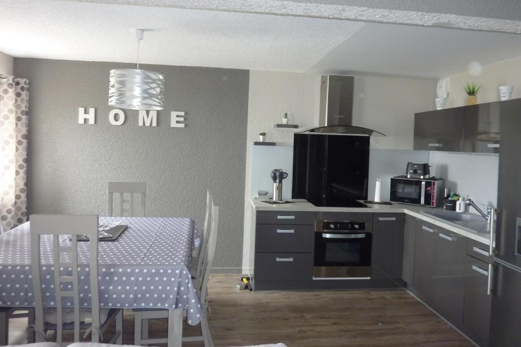 une cuisine avec une table et une salle à manger dans l'établissement Appartement pied des pistes, à Le Mont-Dore