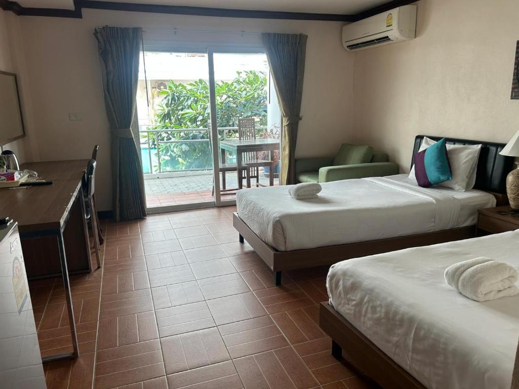 Postel nebo postele na pokoji v ubytování Taj Palace Hotel Patong Beach