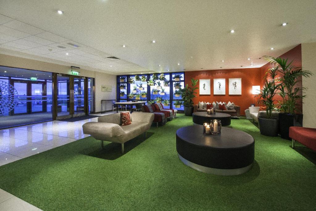 a lobby with couches and chairs and a table at Cork Airport Hotel in Cork