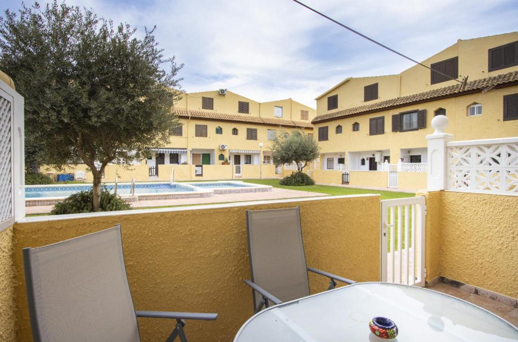 a table and chairs on a balcony with a view of buildings at Casa Vera in Torrevieja