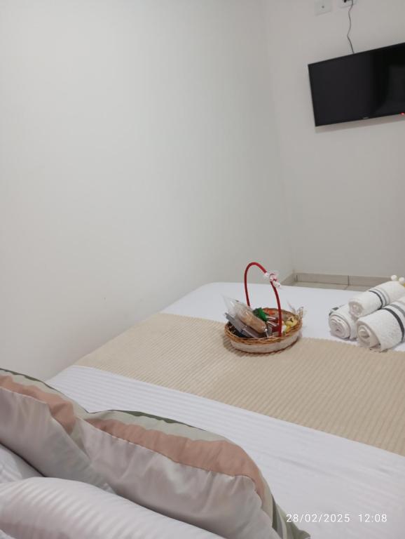 a bed with a basket on top of it at Appartement N01 T3 in Oiapoque