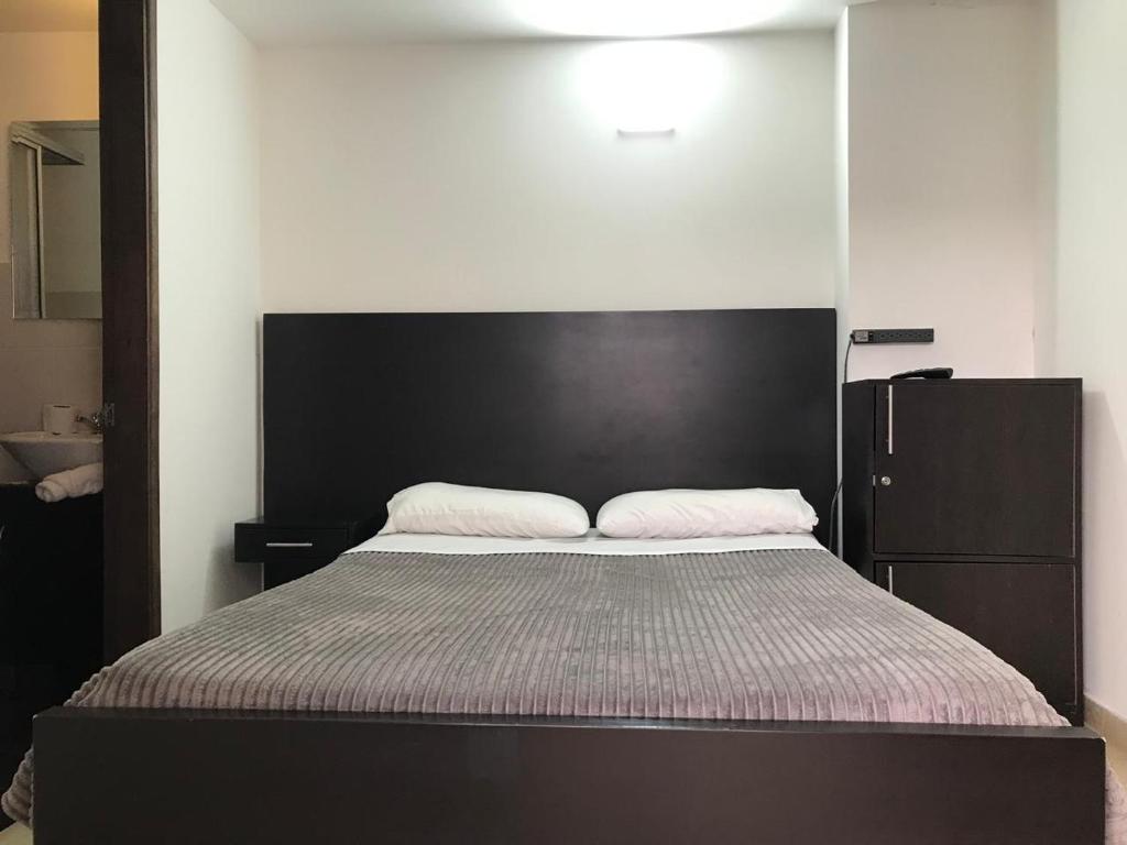 Postel nebo postele na pokoji v ubytování Destino Nómada Calle 11 n 1-38