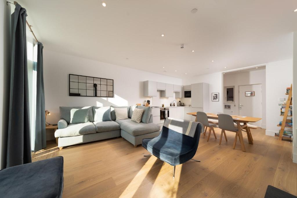 a living room with a couch and a table at Harbour Lookout, Luxury Family Apt, Sea View and Terrace, 2 Bedrooms,1 Bathroom, Parking in Lynmouth