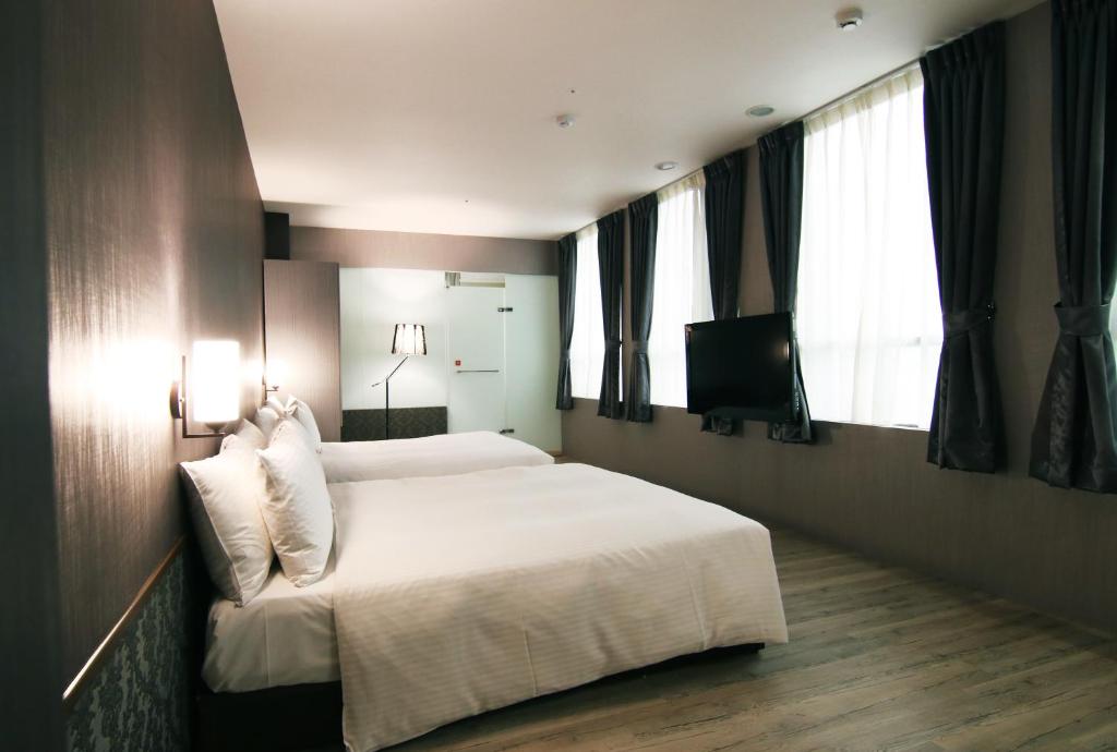 Postel nebo postele na pokoji v ubytování LIHO Hotel Hankou