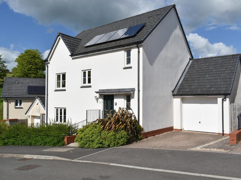 a white house with a black roof at Elizabeth House in Bampton