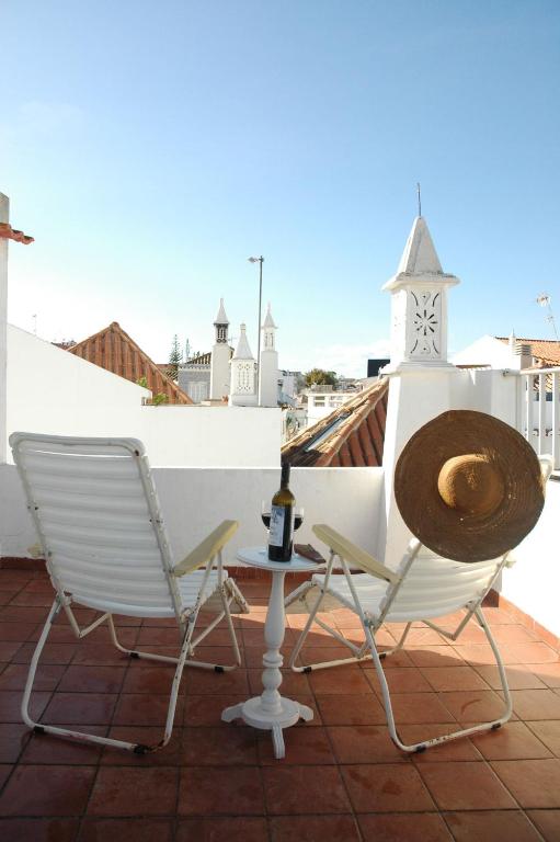 a pair of chairs and a table on a roof at Casa Delgado in Tavira