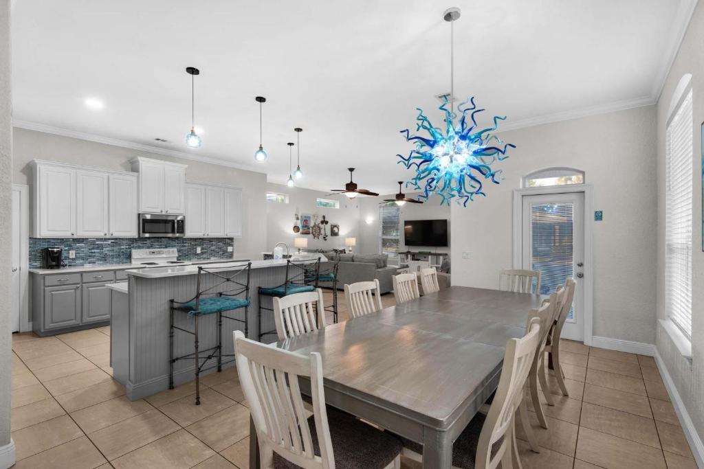 a dining room and kitchen with a table and chairs at Miramar Magic in Destin