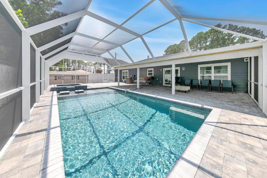 a swimming pool in a house with a roof at Rustic Oasis in Panama City Beach