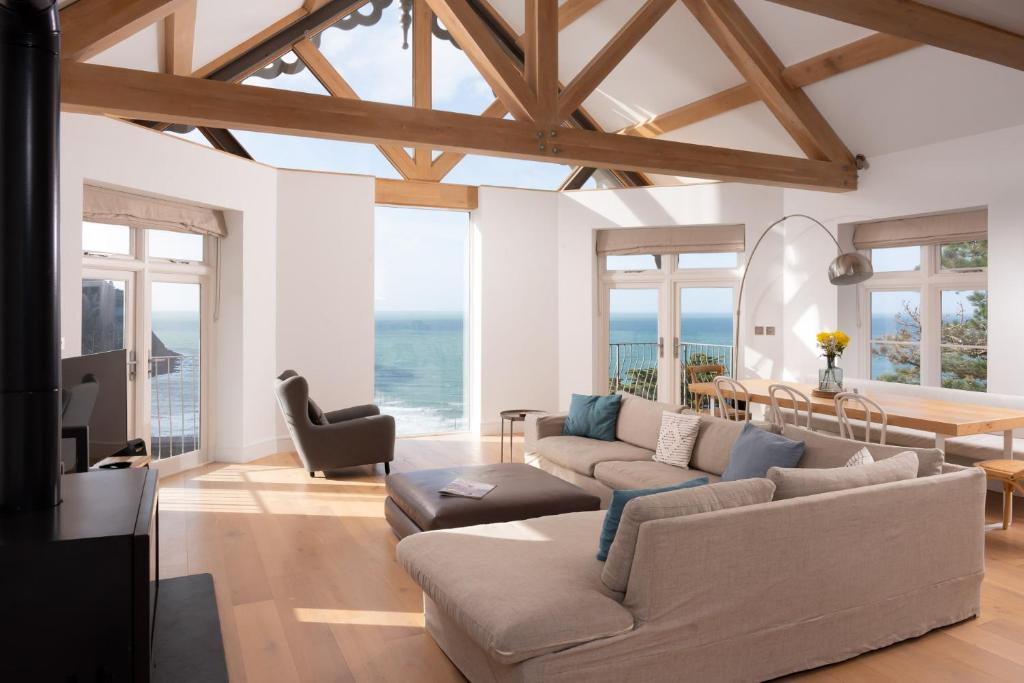 a living room with a couch and a table at Ocean Penthouse, Contemporary Apt, Sleeps 6, Balcony and Terrace, Parking in Lynmouth