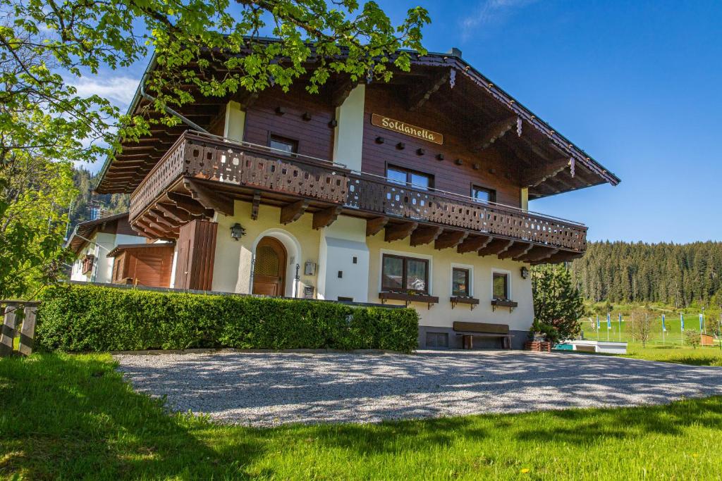 a large house with a balcony on top of it at Soldanella 6 by Alpenidyll Apartments in Ramsau am Dachstein