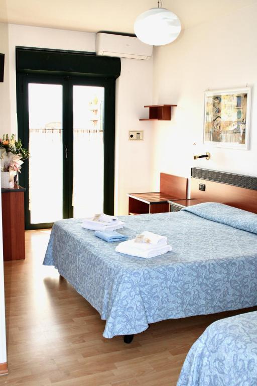Postel nebo postele na pokoji v ubytování Hotel Tassoni Maison