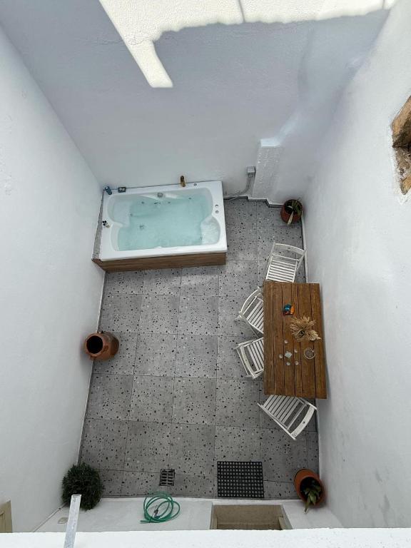 an overhead view of a bathroom with a tub at Philoxenia traditional house private jacuzzi in Palaiólimnos