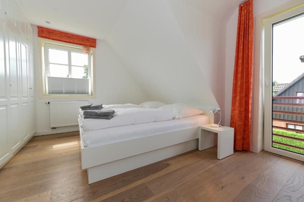 Postel nebo postele na pokoji v ubytování Haus Stine Andresen