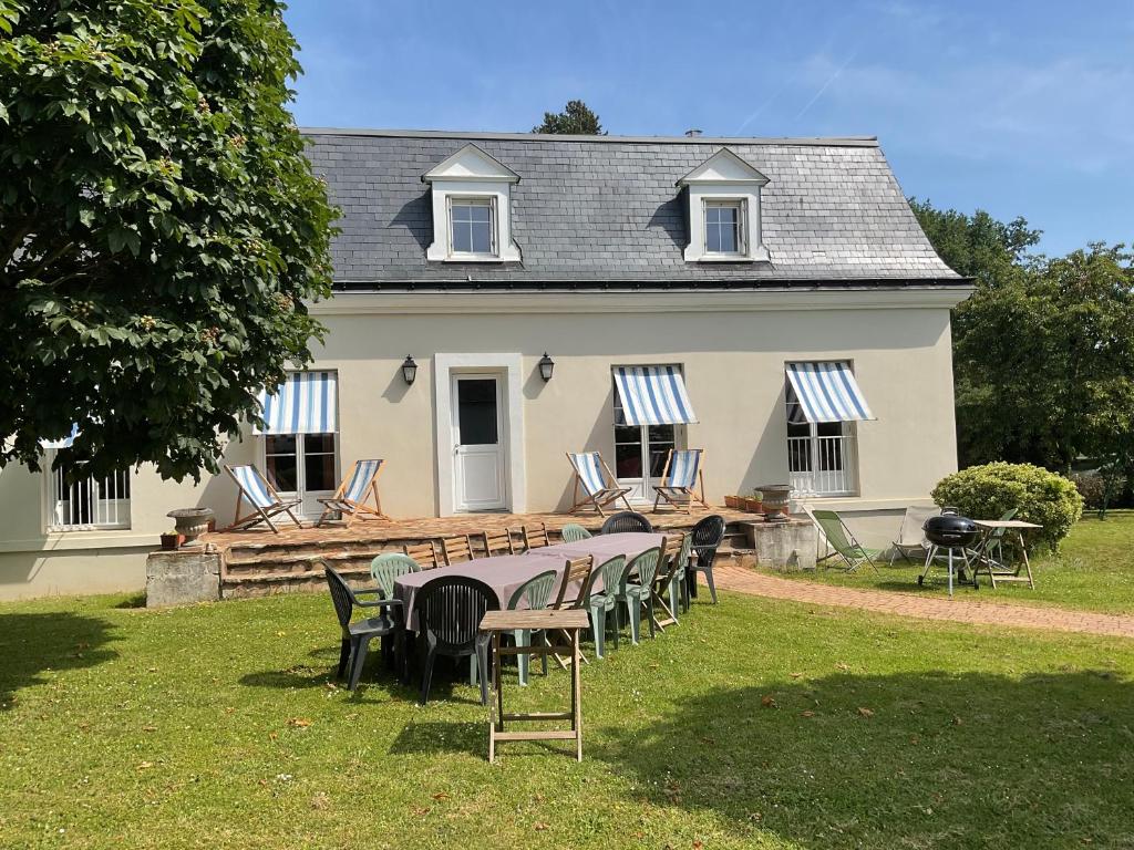 une table et des chaises devant une maison dans l'établissement La maison des retrouvailles aux portes de Tours, à Saint-Avertin