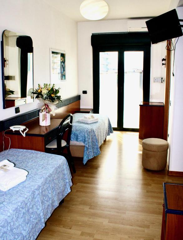 Postel nebo postele na pokoji v ubytování Hotel Tassoni Maison