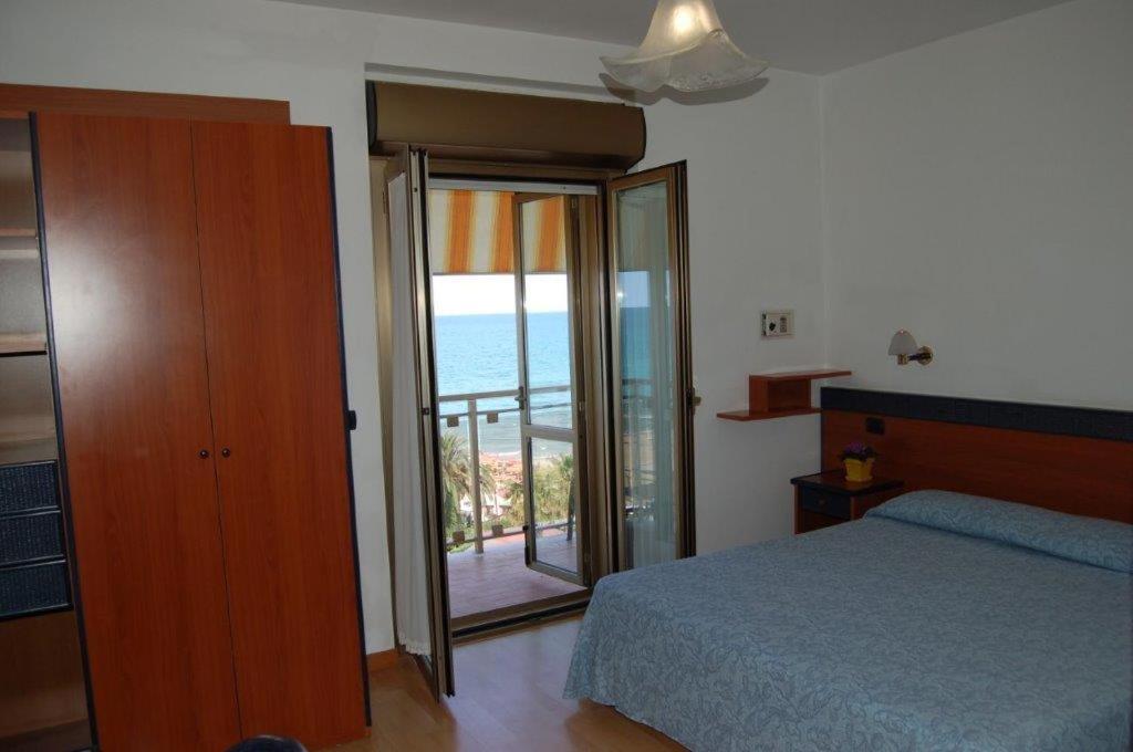 Postel nebo postele na pokoji v ubytování Hotel Tassoni Maison