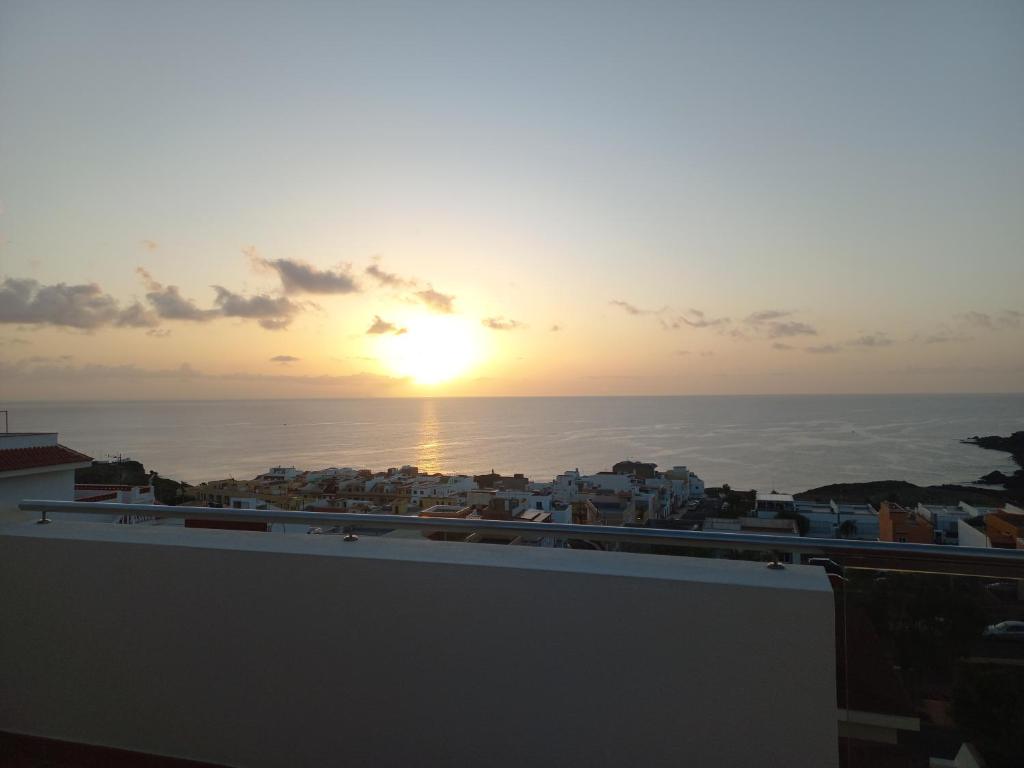 a view of the sunset from the roof of a building at VILLA CHRIS Ocean View in La Jaca
