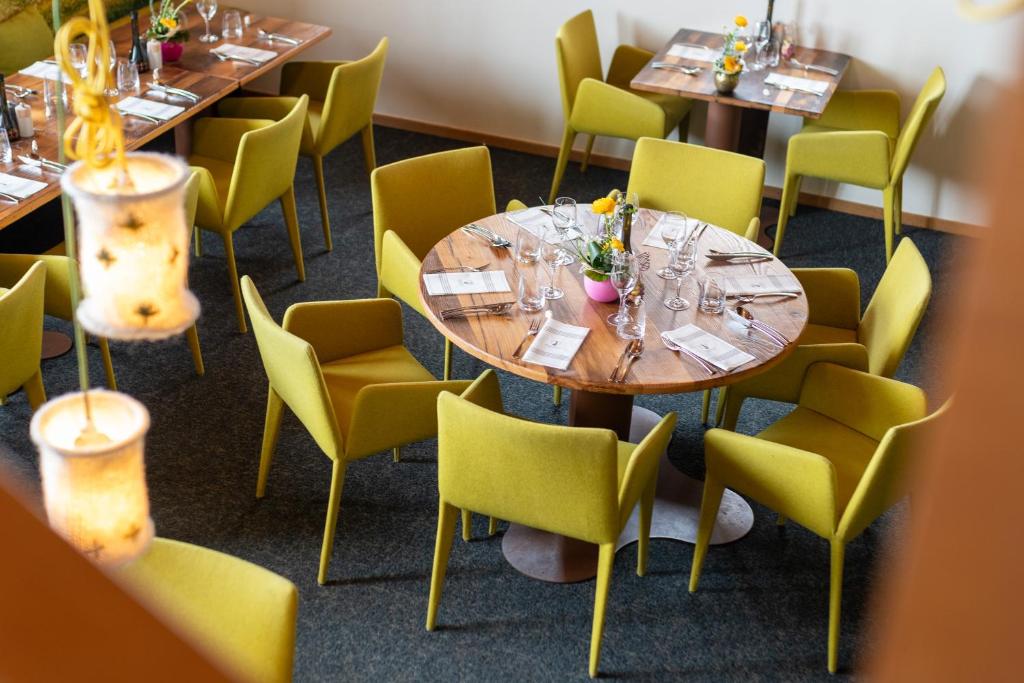 a dining room with tables and chairs with glasses at Hotel Pashmina Le Refuge in Val Thorens