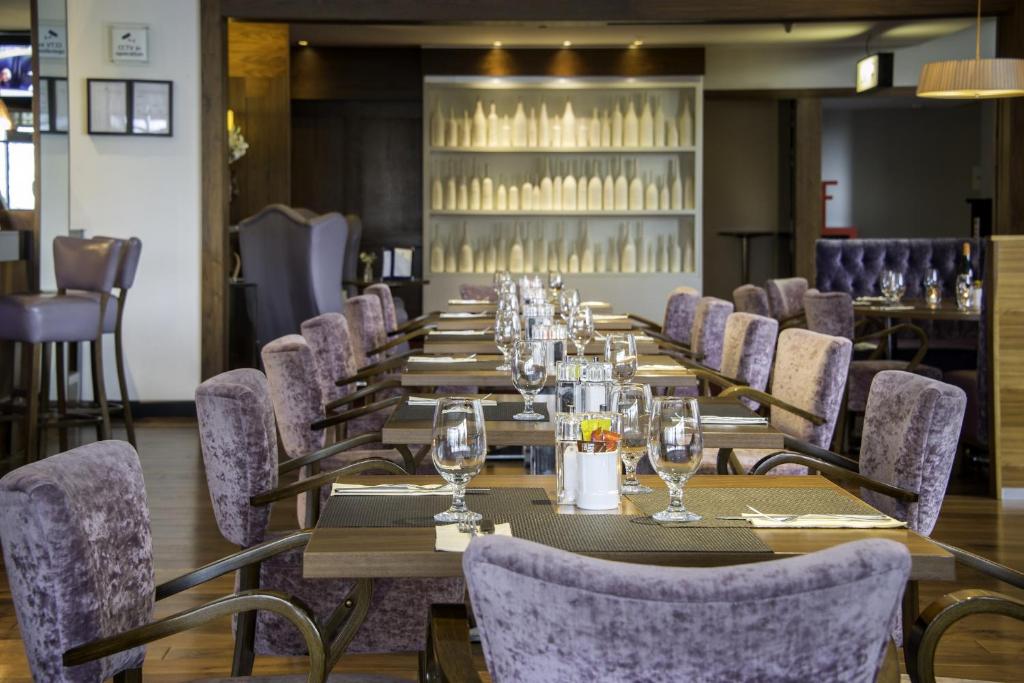 a row of tables and chairs in a restaurant at Cork International Hotel in Cork