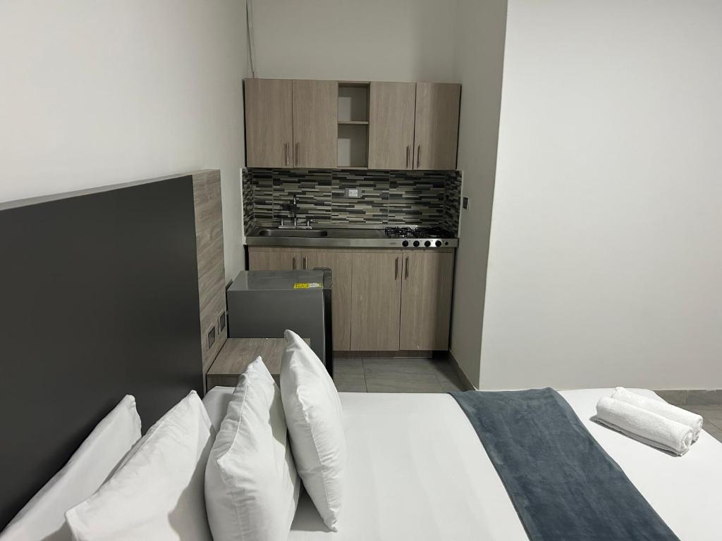 Postel nebo postele na pokoji v ubytování Hotel Ciento Once Boutique Laureles