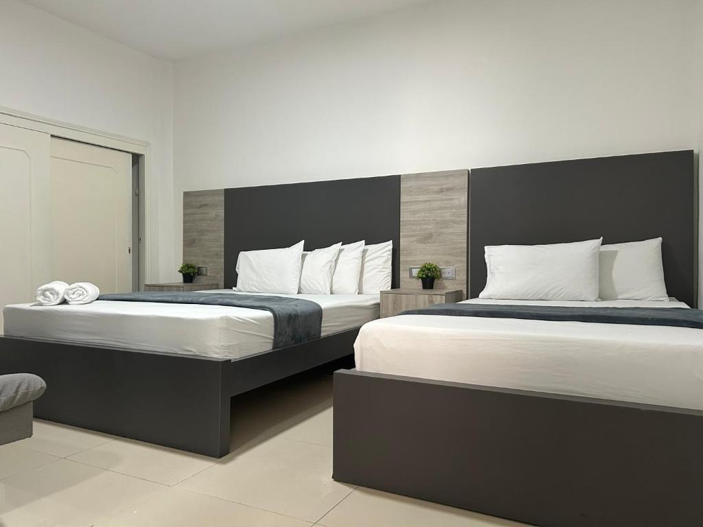 Postel nebo postele na pokoji v ubytování Hotel Ciento Once Boutique Laureles