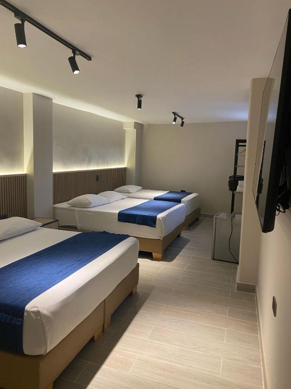 Postel nebo postele na pokoji v ubytování Hotel Suramericana