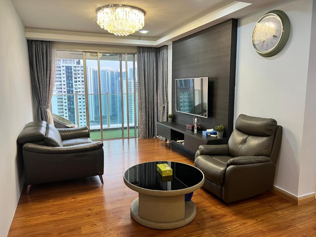 a living room with two chairs and a television at Maxim Citylight Jln Sentul paser in Kuala Lumpur