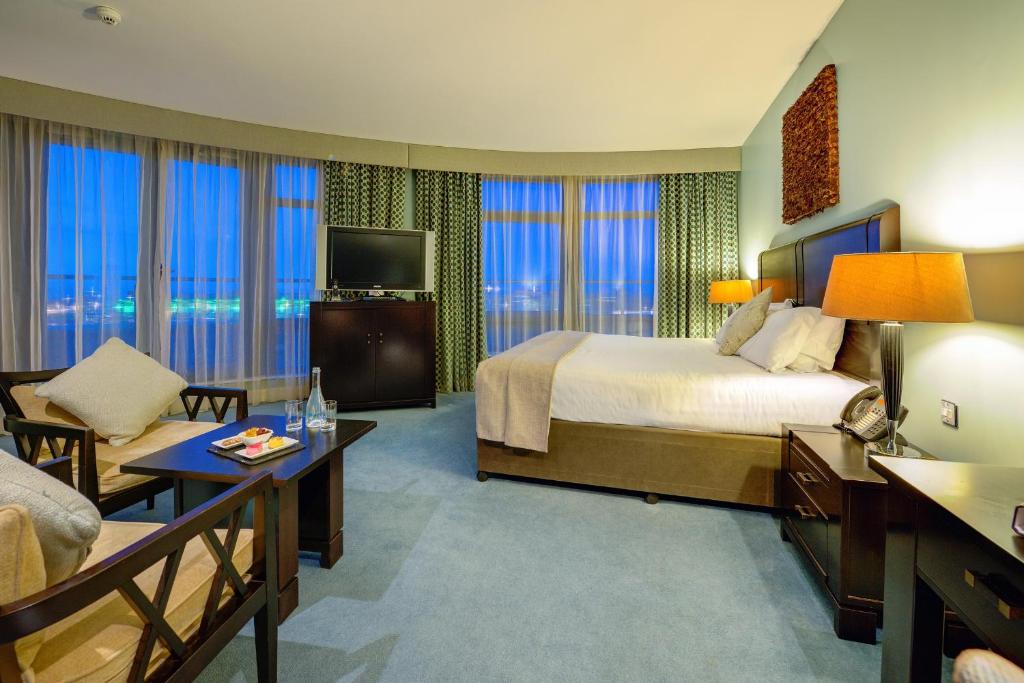 a large hotel room with a bed and a couch at Cork International Hotel in Cork