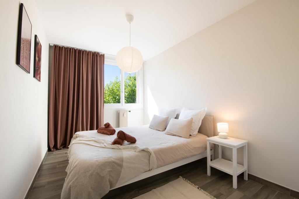 une chambre avec un lit avec deux ours en peluche dessus dans l'établissement Chez Ambre et Flo - Queen Size Clim Centre Parking, à Saint-Raphaël