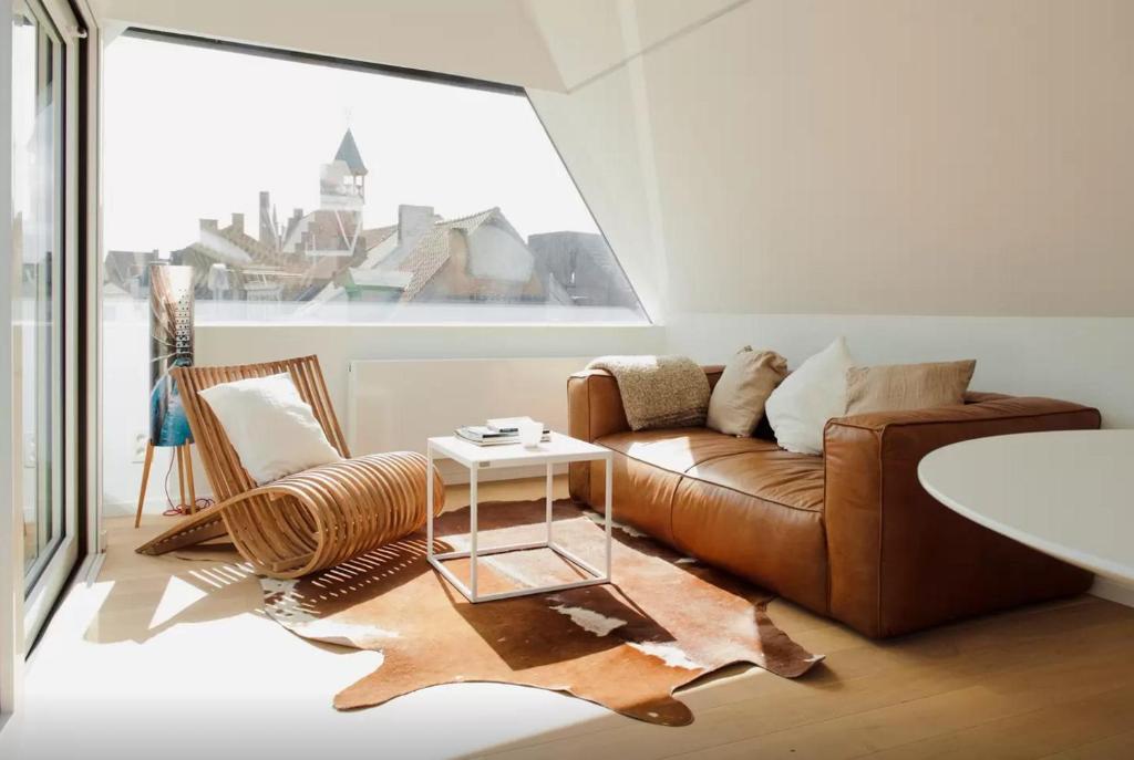 a living room with a couch and a table at The Flat Gent in Ghent
