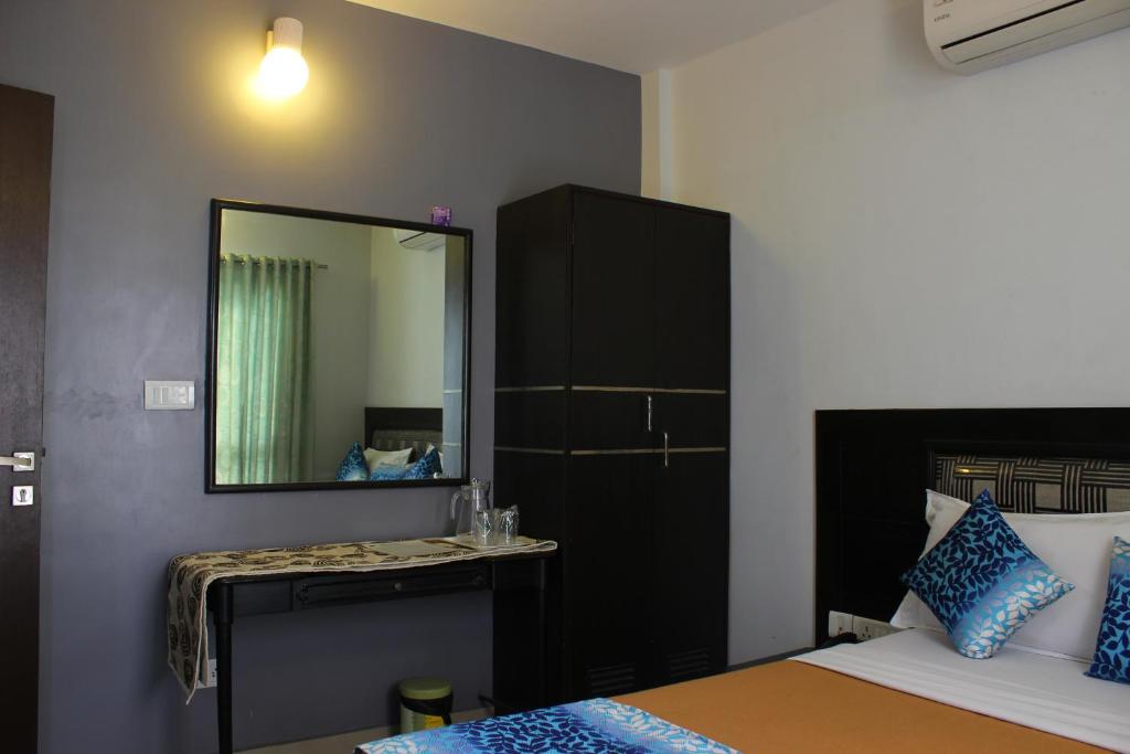 Postel nebo postele na pokoji v ubytování Mount Residency