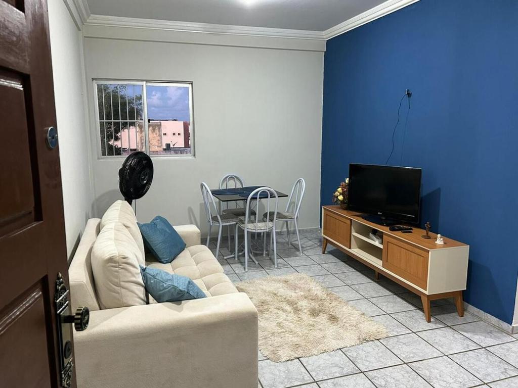 a living room with a couch and a tv at Apartamento em Natal-RN in Natal