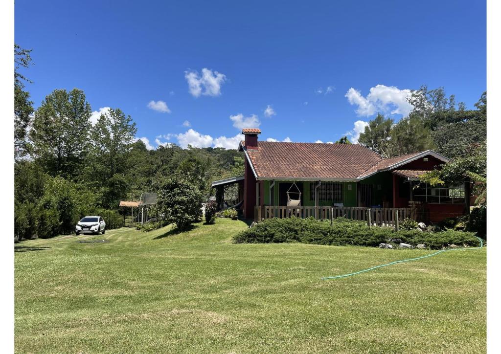 a house with a car parked in front of it at Cantinho da Cerejeira in Santo Antônio do Pinhal