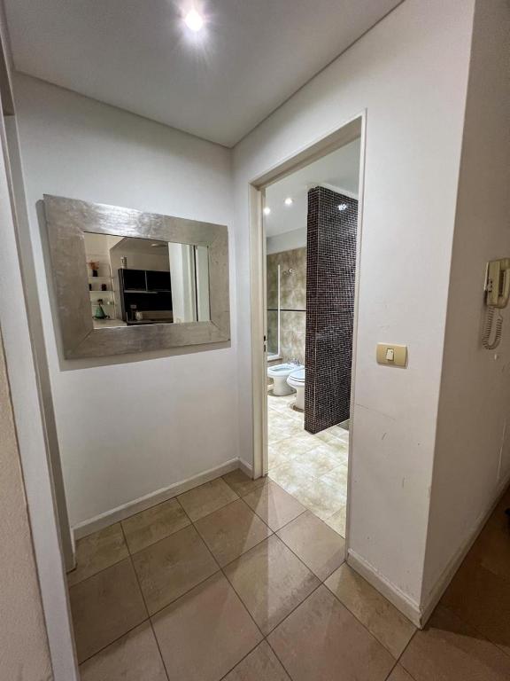 a room with a bathroom with a mirror and a door at Crucero Puerto in Buenos Aires