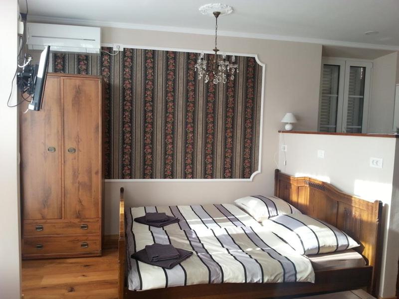 a bedroom with two beds and a window with a curtain at Carrera Grande Apartment in Piran