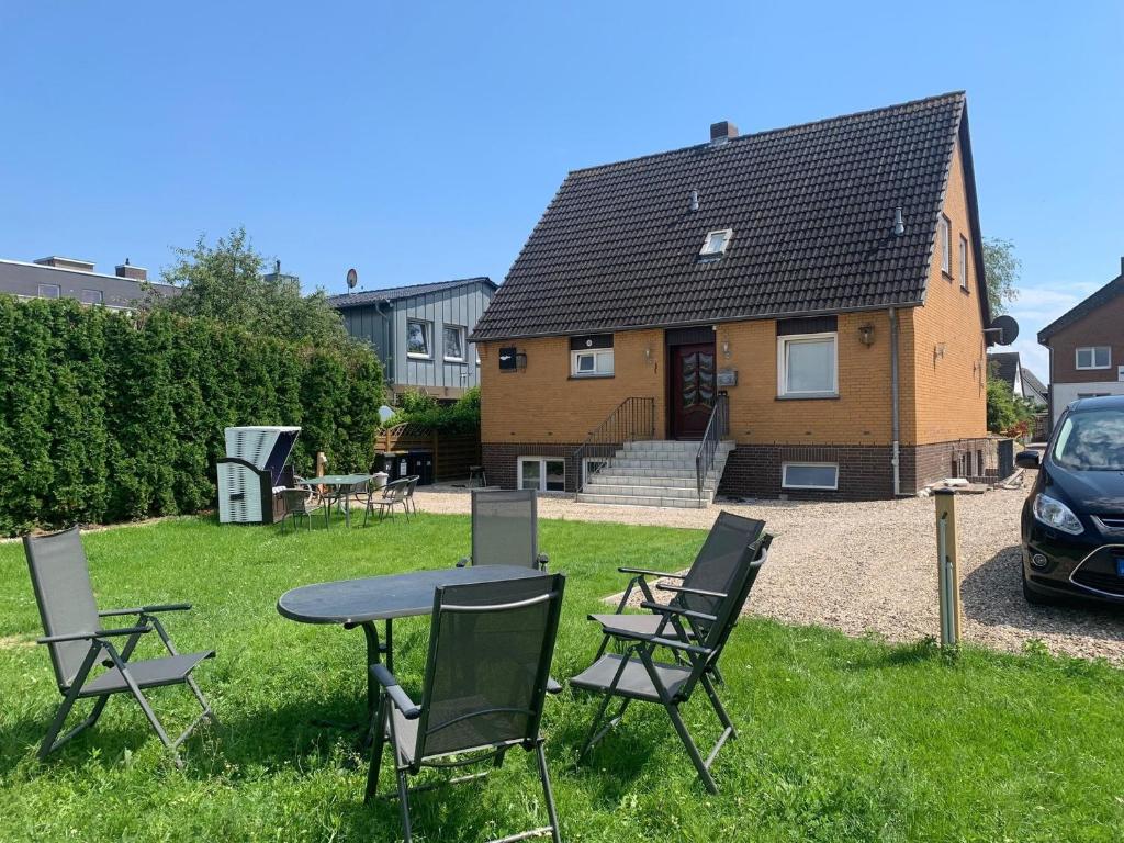 a table and chairs in the yard of a house at Haus Ostwind - Wohnung 3 in Dahme