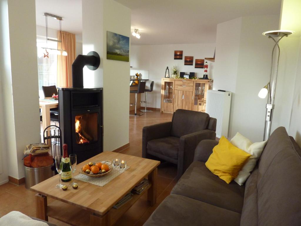 a living room with a couch and a fireplace at Ostseebrise 14 - Großenbrode in Grossenbrode