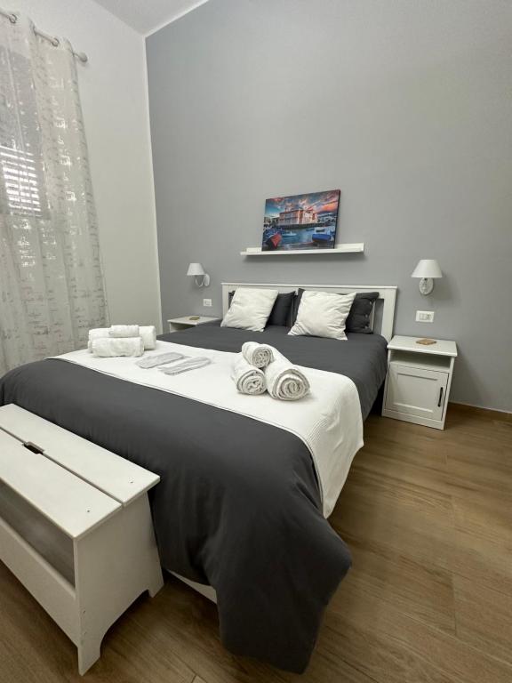 a bedroom with a large bed with towels on it at Apulia White House 59 in Bari