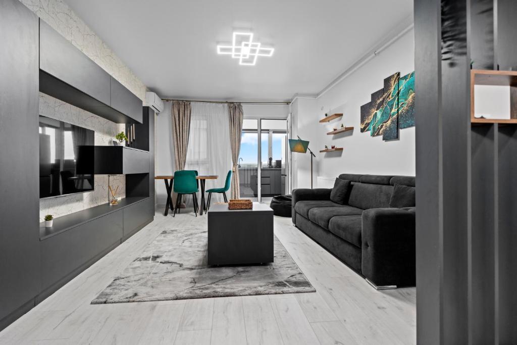 a living room with a couch and a table at Minimalist Green & Grey Flat in Bucharest