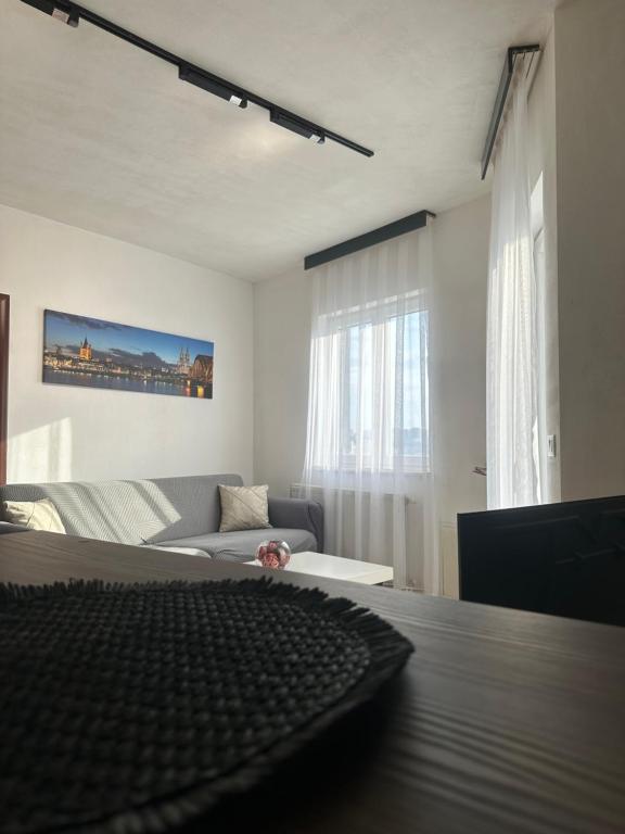 a white bedroom with a bed and a couch at BT Apartments 2 in Pristina