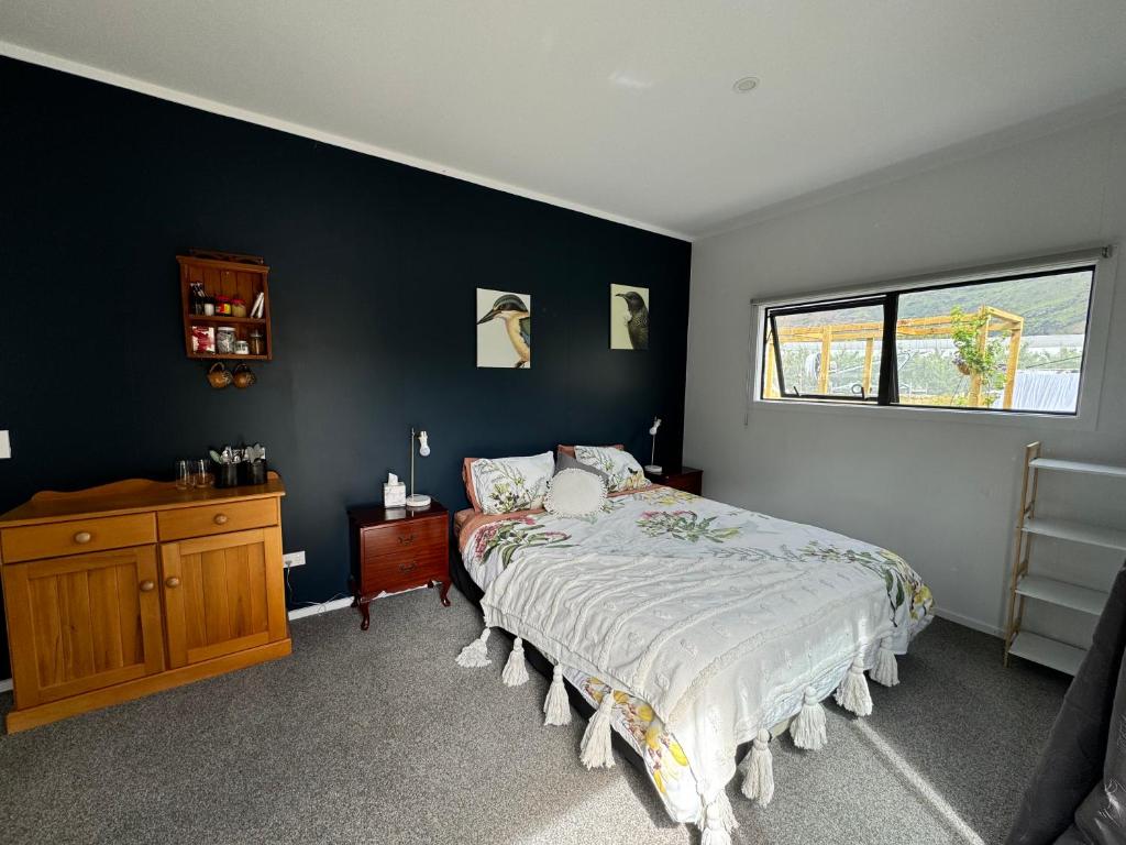a bedroom with a bed and a wooden dresser at Comfortable Barn Stay on Private Rural Property in Cromwell in Cromwell