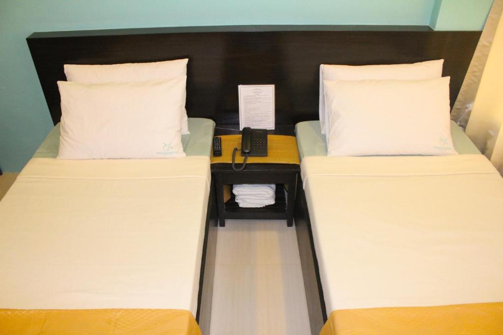 Postel nebo postele na pokoji v ubytování Coron Visitors Hotel